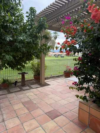 a backyard of a house with table and chairs