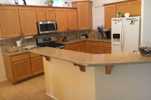 a kitchen with stainless steel appliances a sink and a refrigerator