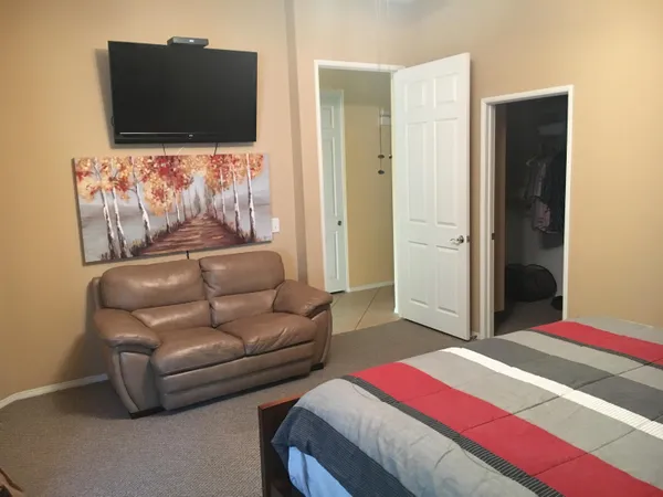 a bedroom with a bed and a dresser