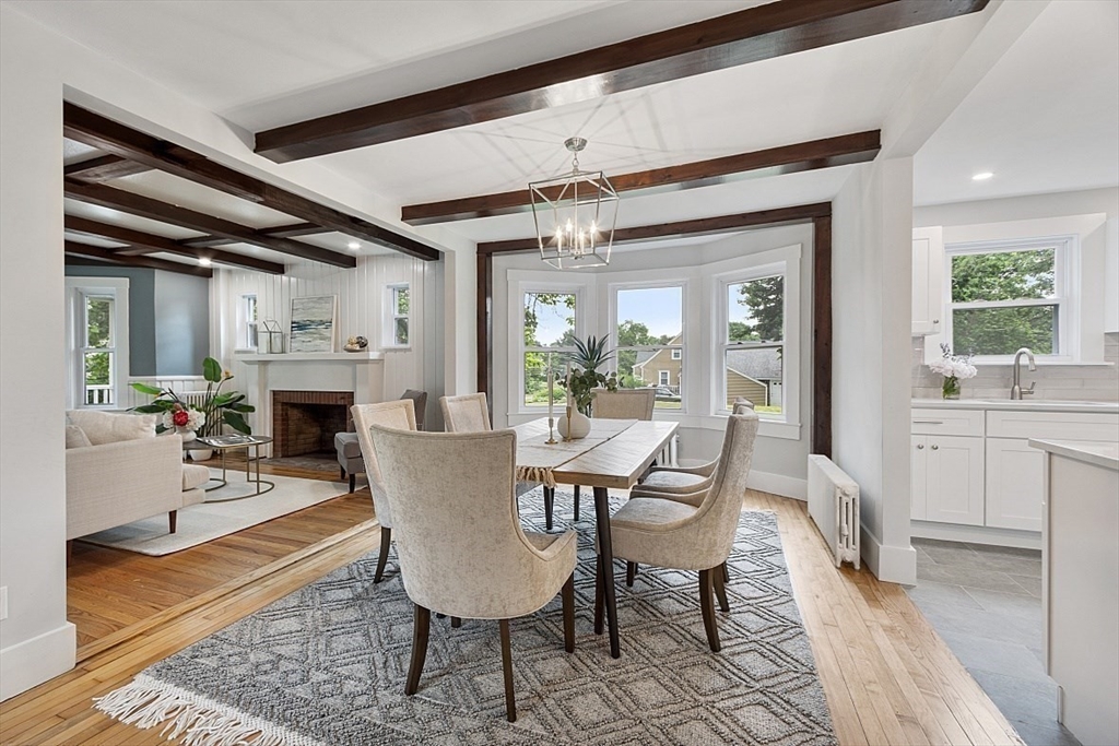 136 Groton Road North Chelmsford, MA 01863 - Photo 14 of 41 a dining room with furniture a fireplace and wooden floor