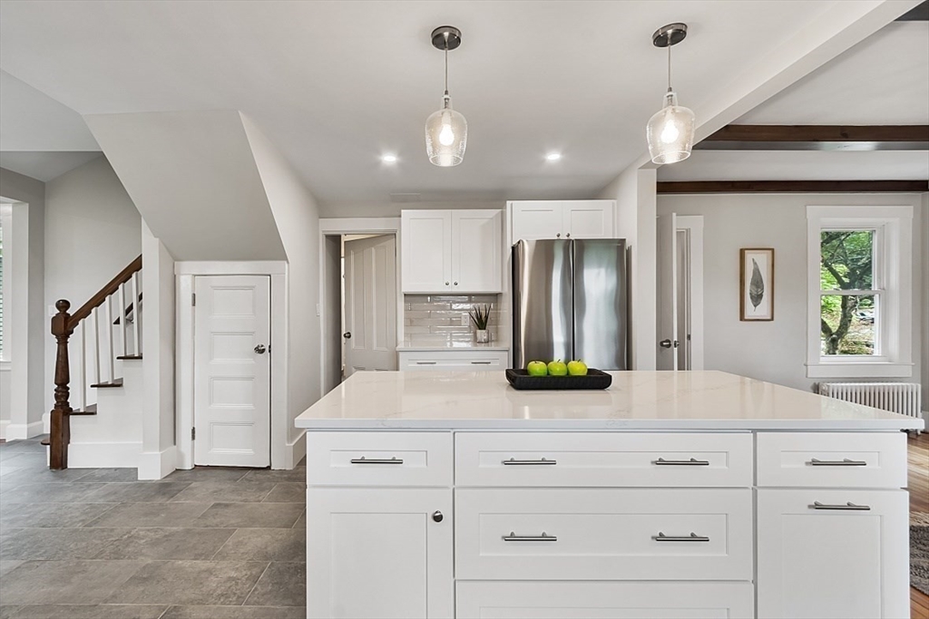 136 Groton Road North Chelmsford, MA 01863 - Photo 20 of 41 a view of a kitchen with a refrigerator and microwave