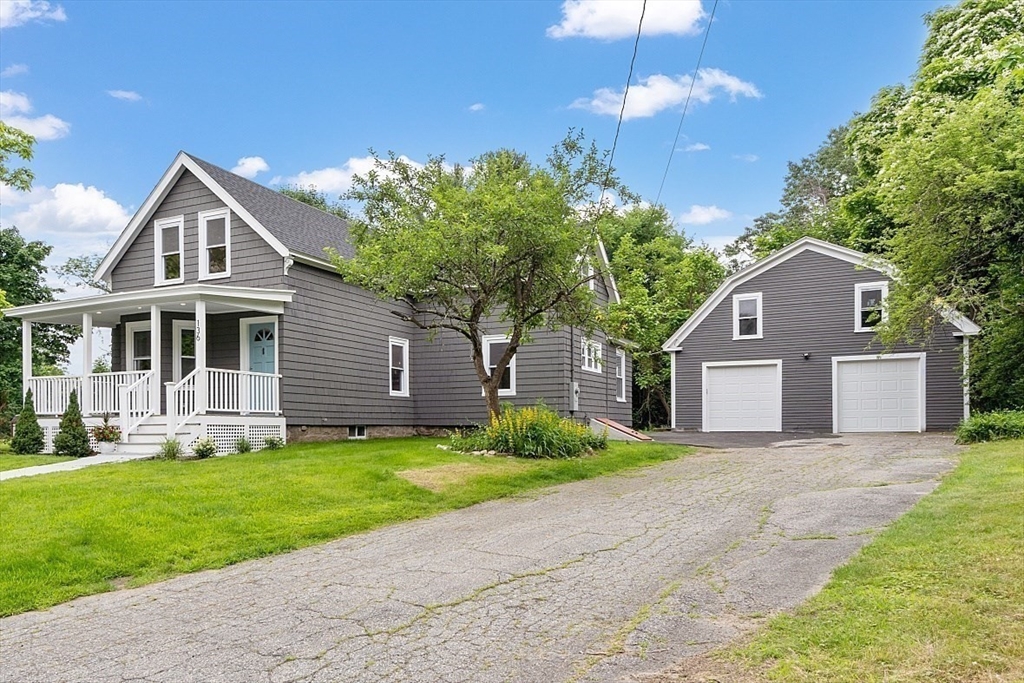 136 Groton Road North Chelmsford, MA 01863 - Photo 3 of 41 a front view of a house with a yard and garage