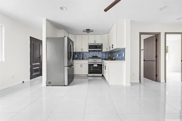 a kitchen with stainless steel appliances a refrigerator and a stove top oven
