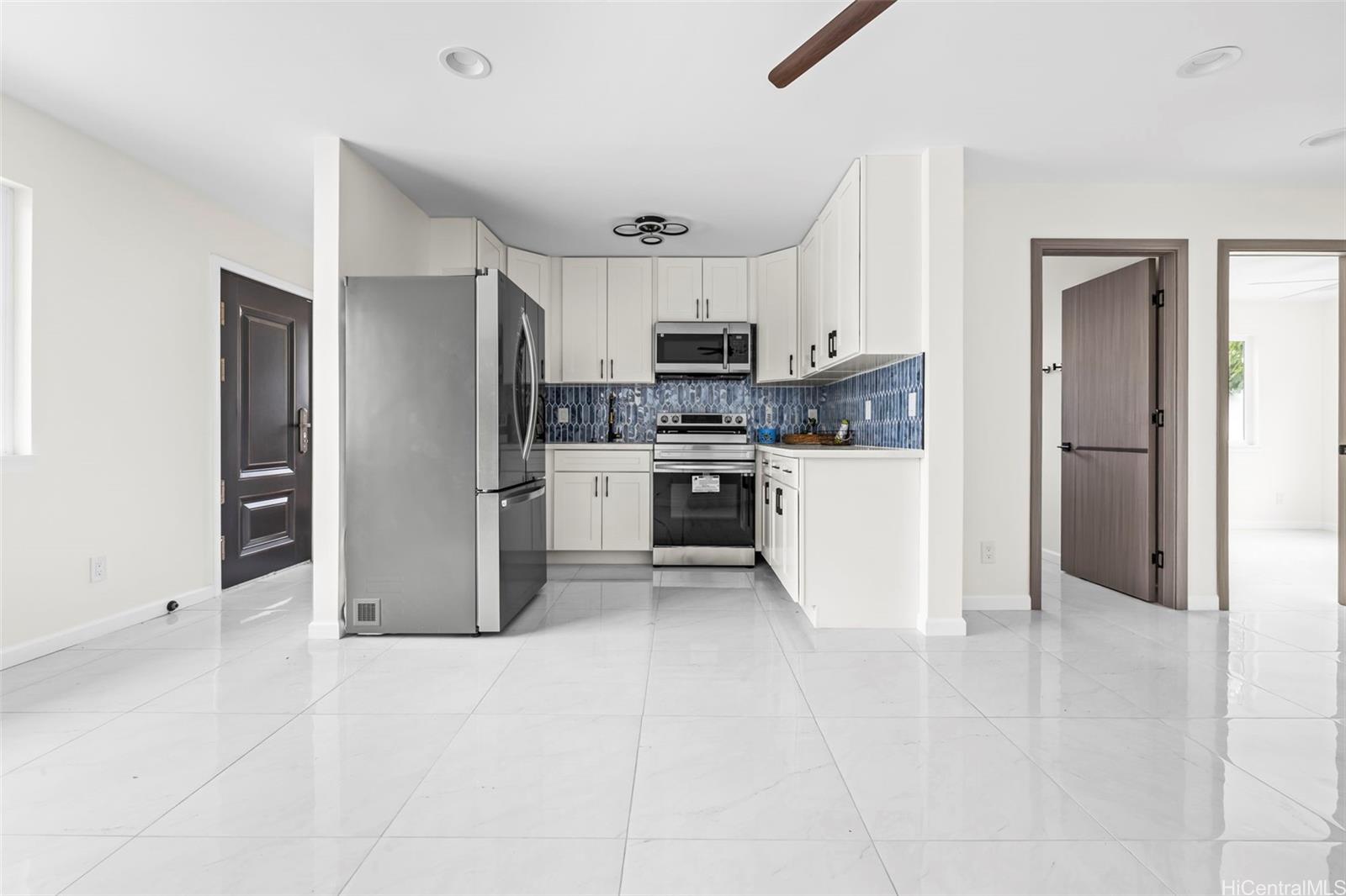 a kitchen with stainless steel appliances a refrigerator and a stove top oven
