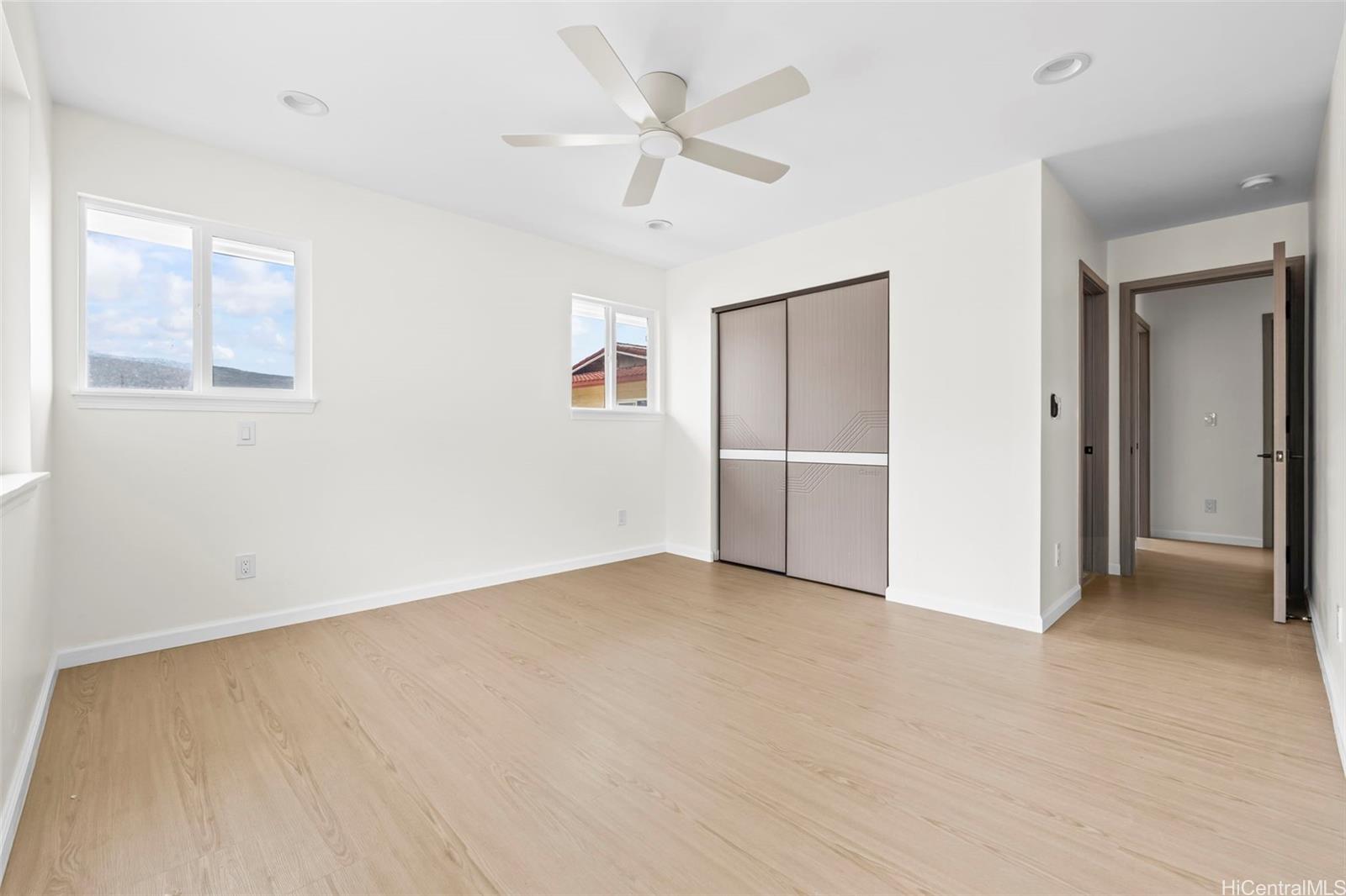 87-1474 Akowai Road, Unit A Waianae, HI 96792 - Photo 11 of 25 an empty room with closet and windows