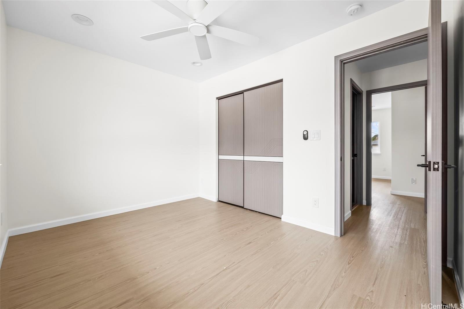 87-1474 Akowai Road, Unit A Waianae, HI 96792 - Photo 13 of 25 an empty room with wooden floor closet and windows