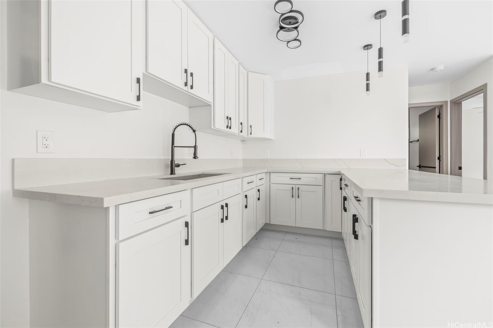 87-1474 Akowai Road, Unit A Waianae, HI 96792 - Photo 18 of 25 a view of a kitchen with cabinets