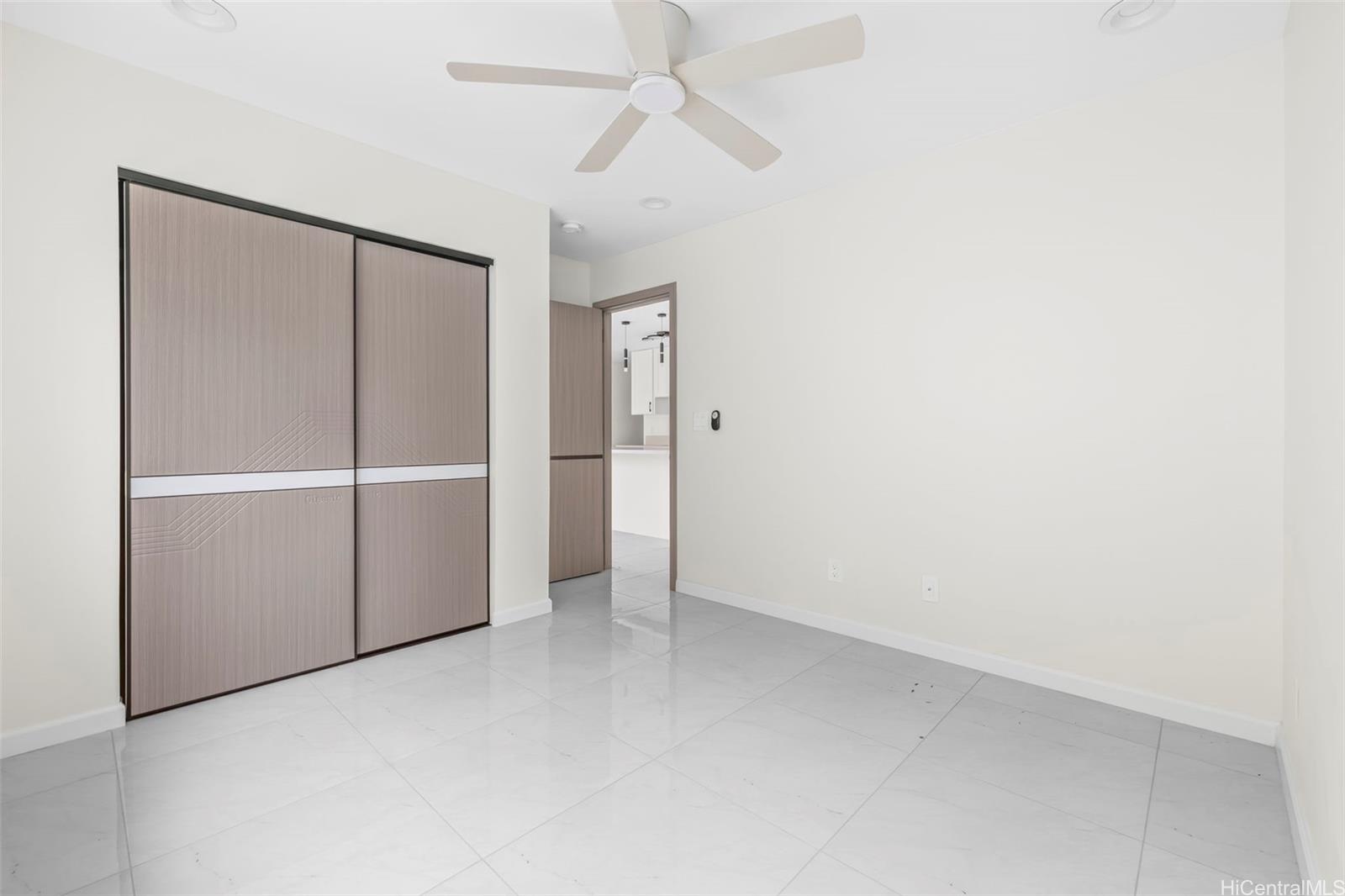 87-1474 Akowai Road, Unit A Waianae, HI 96792 - Photo 20 of 25 an empty room with closet and a ceiling fan