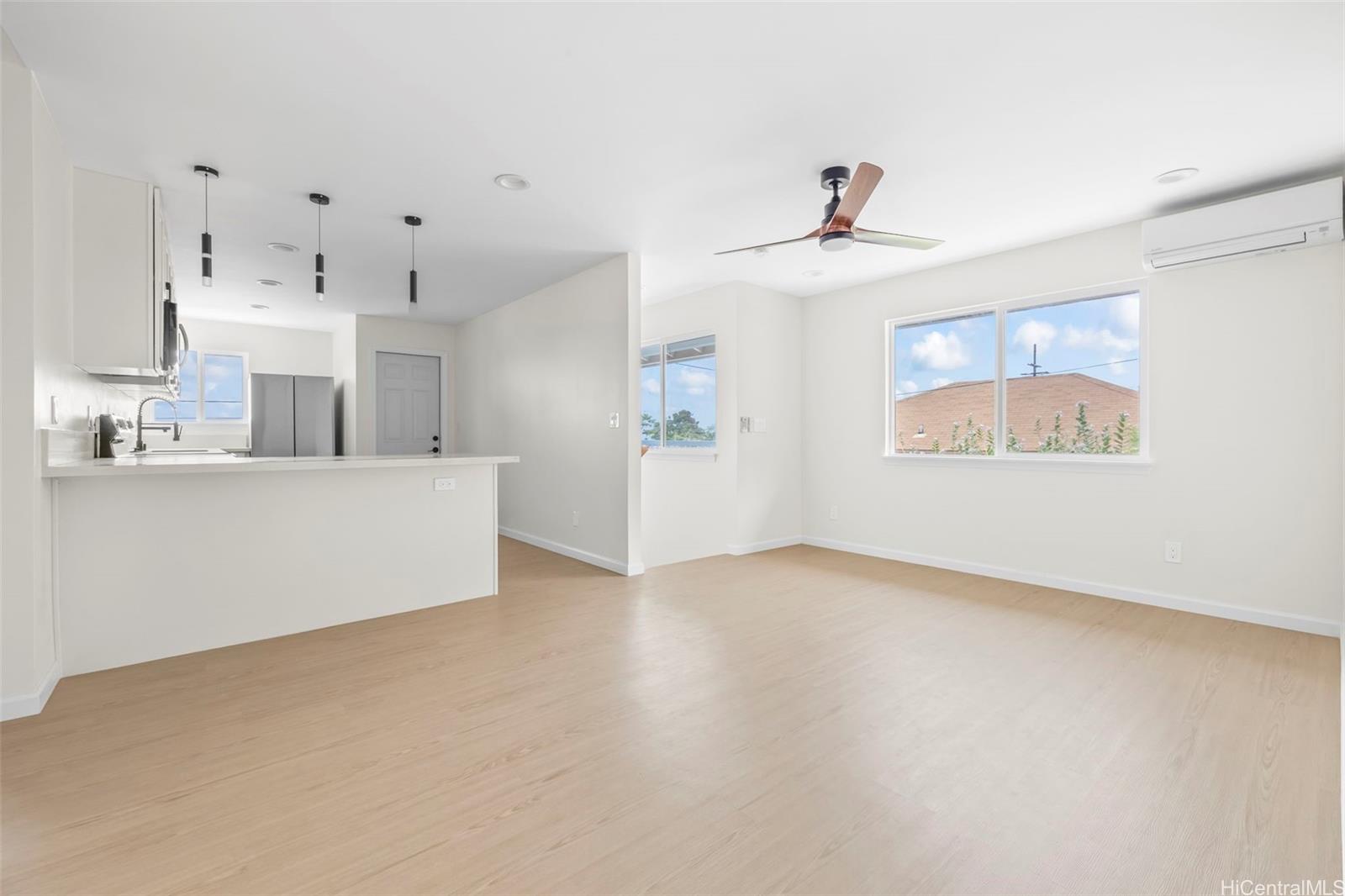 87-1474 Akowai Road, Unit A Waianae, HI 96792 - Photo 22 of 25 a view of a kitchen with furniture and a ceiling fan