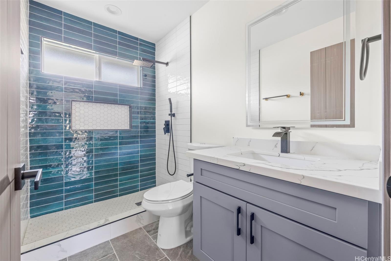87-1474 Akowai Road, Unit A Waianae, HI 96792 - Photo 23 of 25 a bathroom with a granite countertop sink toilet and shower