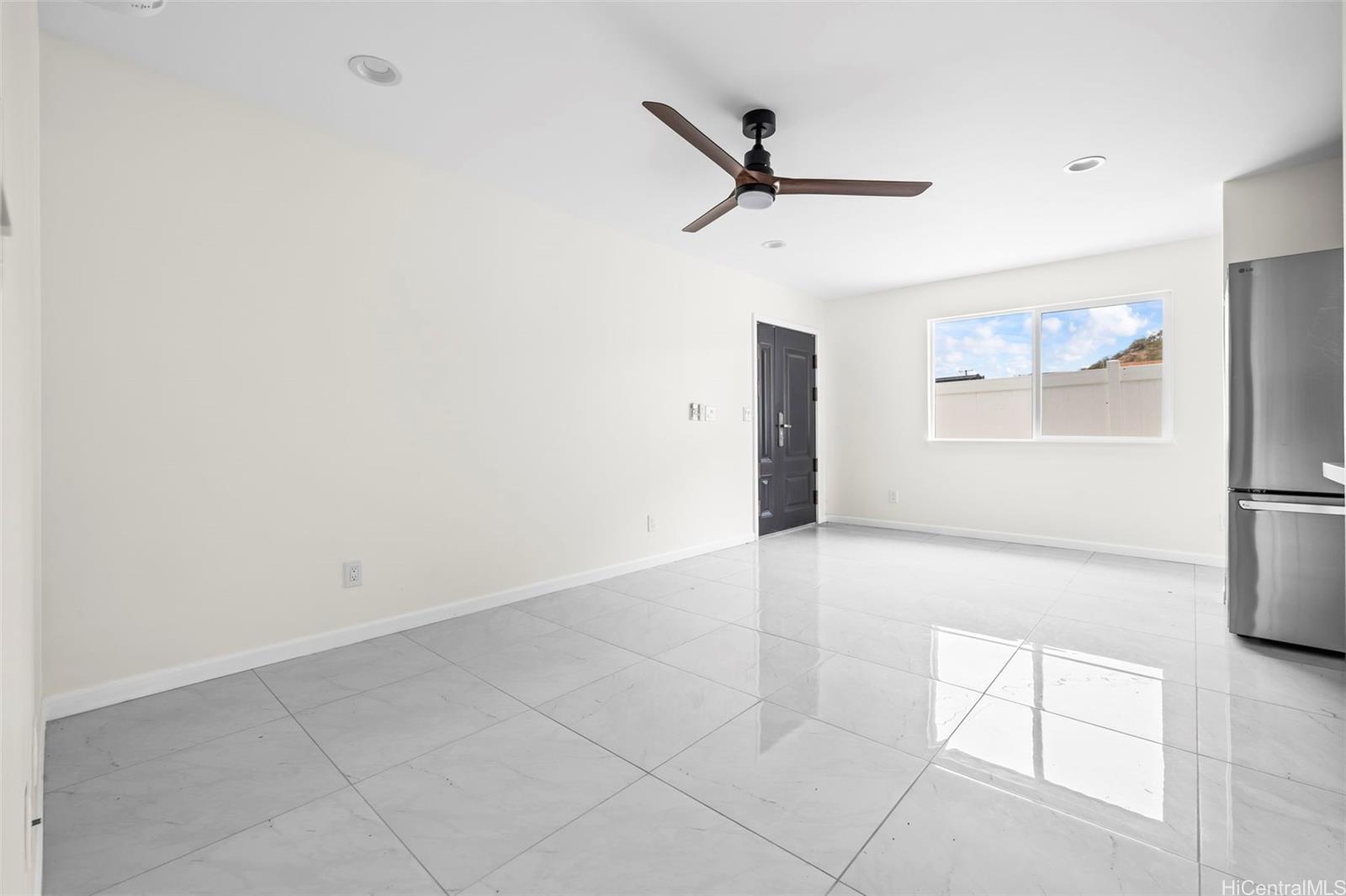 87-1474 Akowai Road, Unit A Waianae, HI 96792 - Photo 3 of 25 a view of a livingroom with a dishwasher and a refrigerator