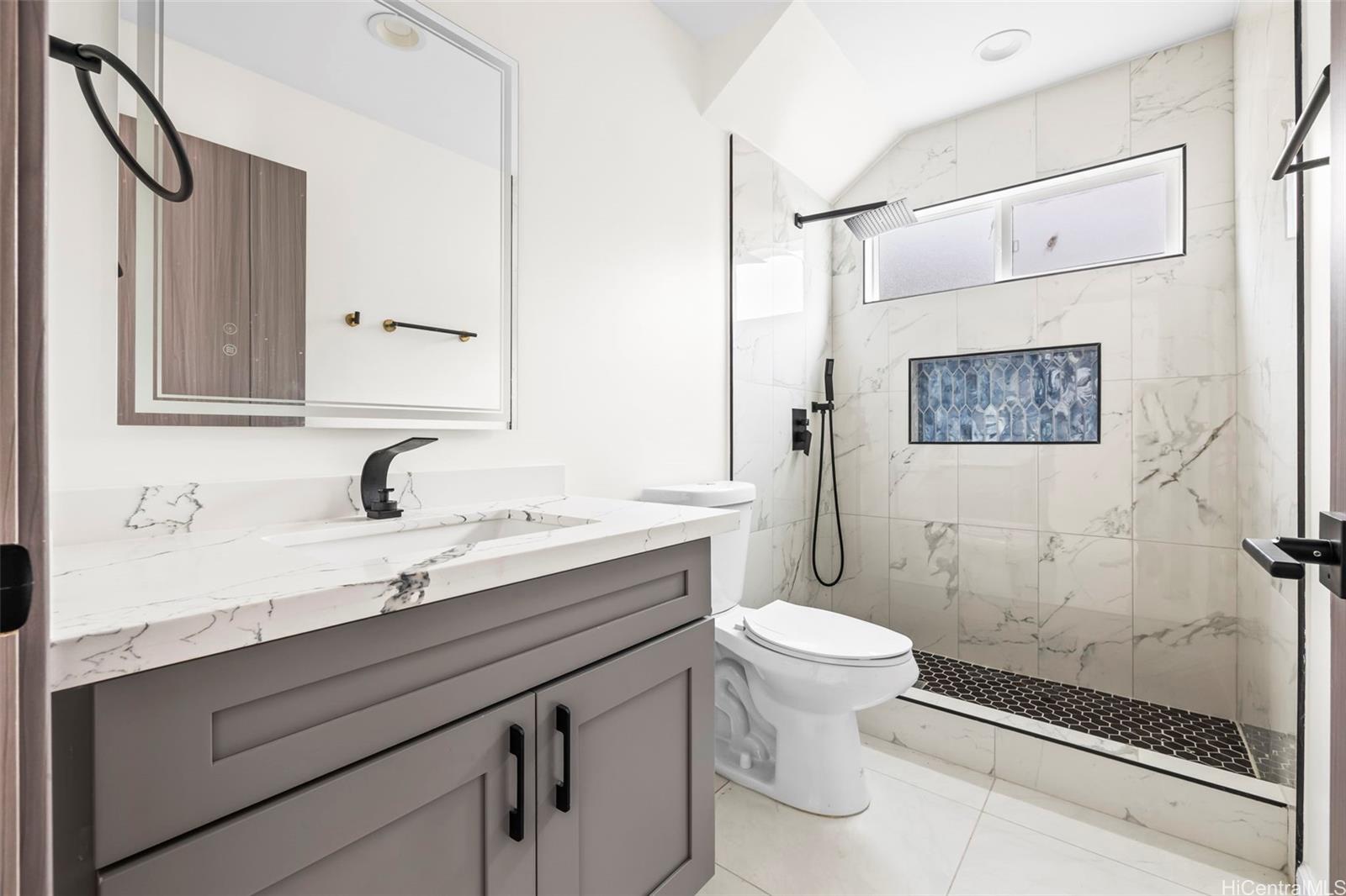 87-1474 Akowai Road, Unit A Waianae, HI 96792 - Photo 6 of 25 a bathroom with a sink a toilet and shower