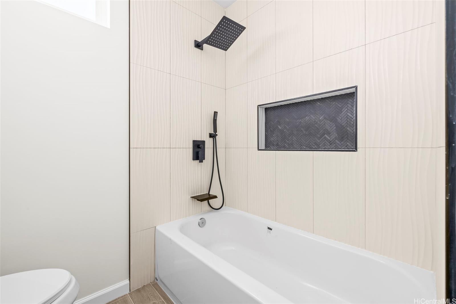 87-1474 Akowai Road, Unit A Waianae, HI 96792 - Photo 7 of 25 a bathroom with a toilet sink and bathtub