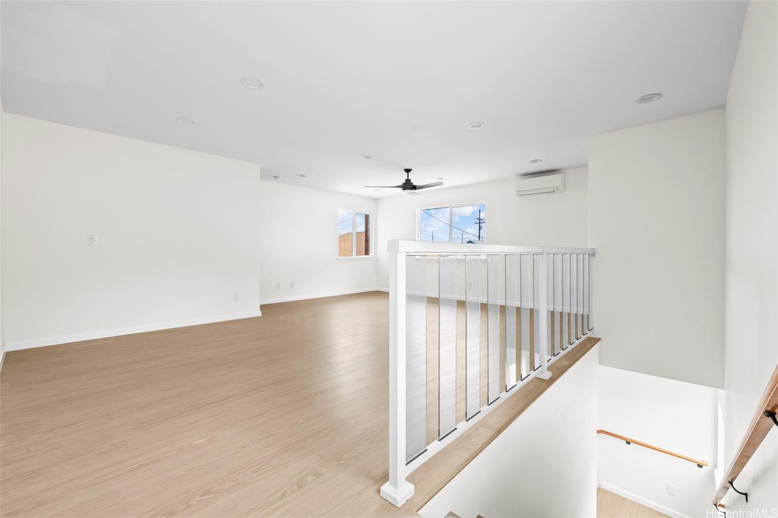 87-1474 Akowai Road, Unit A Waianae, HI 96792 - Photo 9 of 25 a view of a hallway with white walls and stairs