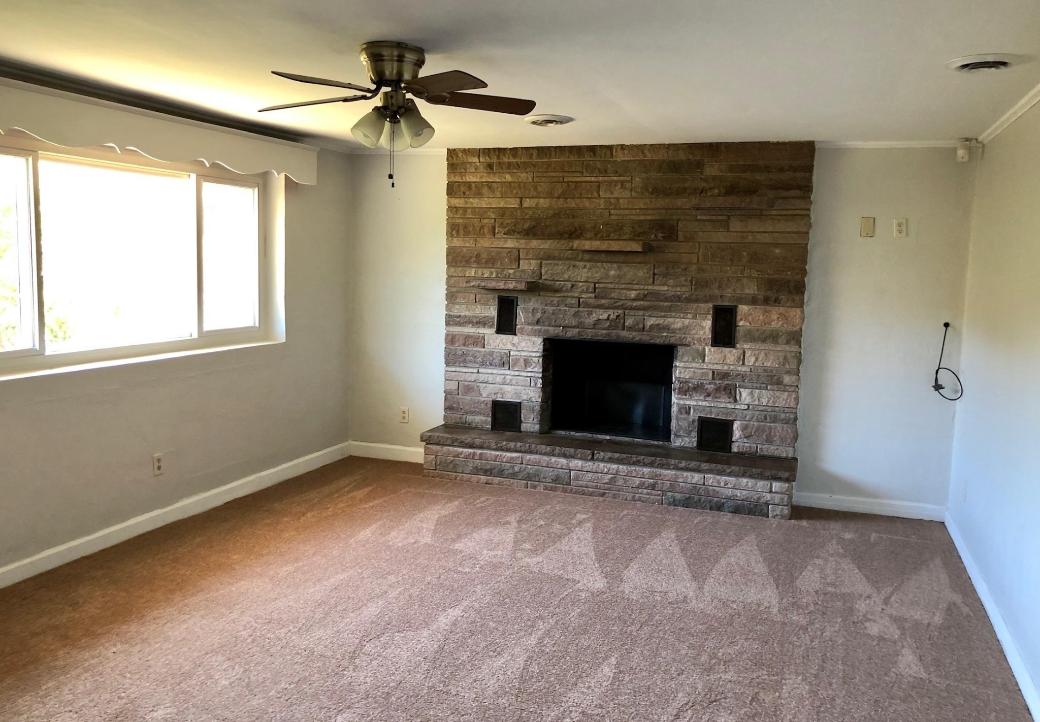 815 Lohman Road Sevierville, TN 37876 - Photo 5 of 14 an empty room with windows and fireplace