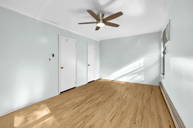 a view of empty room with wooden floor