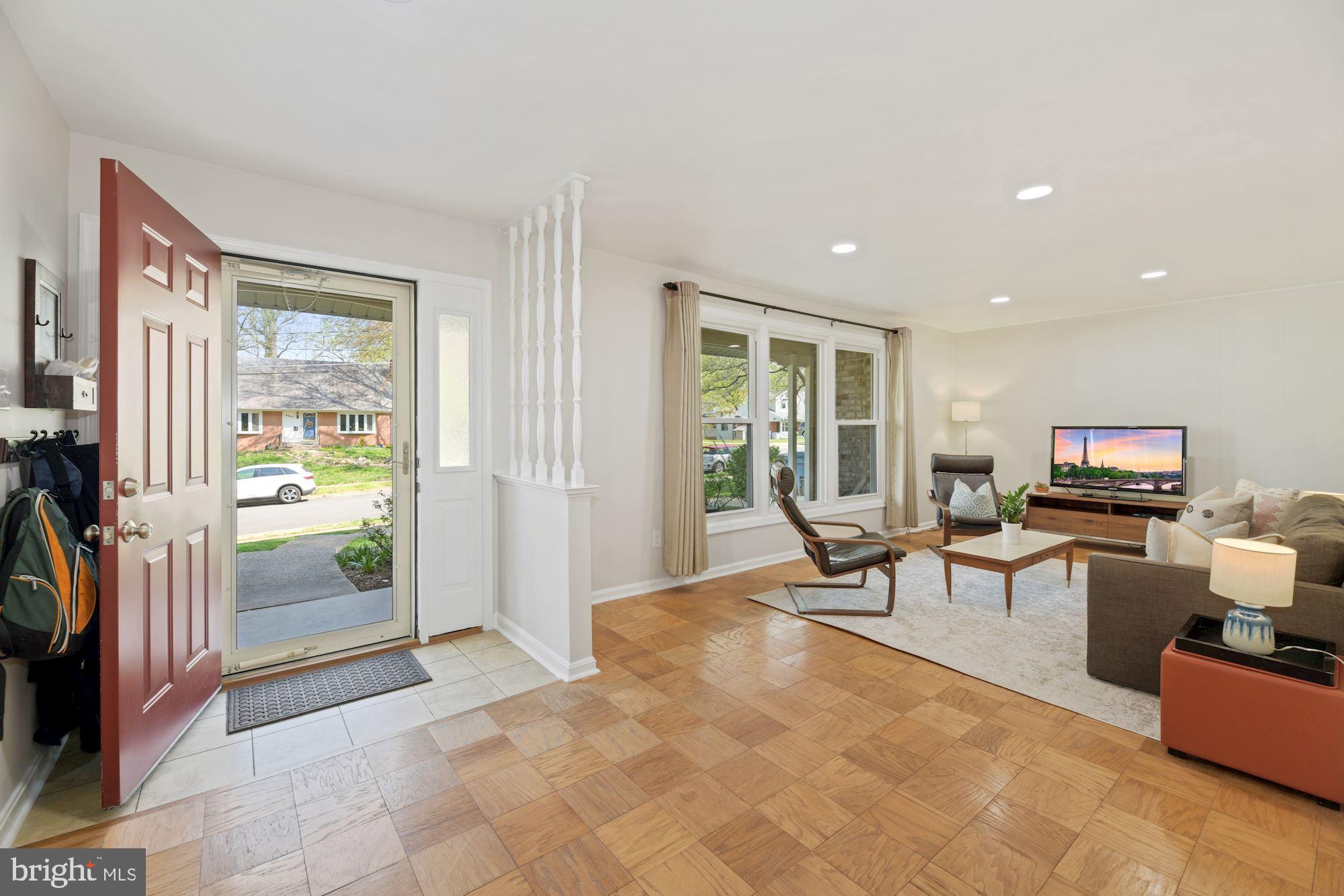 5228 Perth Court Springfield, VA 22151 - Photo 2 of 26 a living room with furniture a flat screen tv and large window