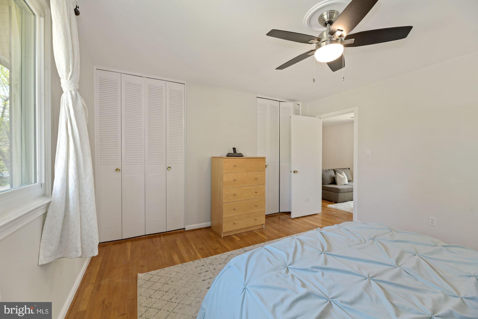5228 Perth Court Springfield, VA 22151 - Photo 17 of 26 a bedroom with a bed and a chandelier