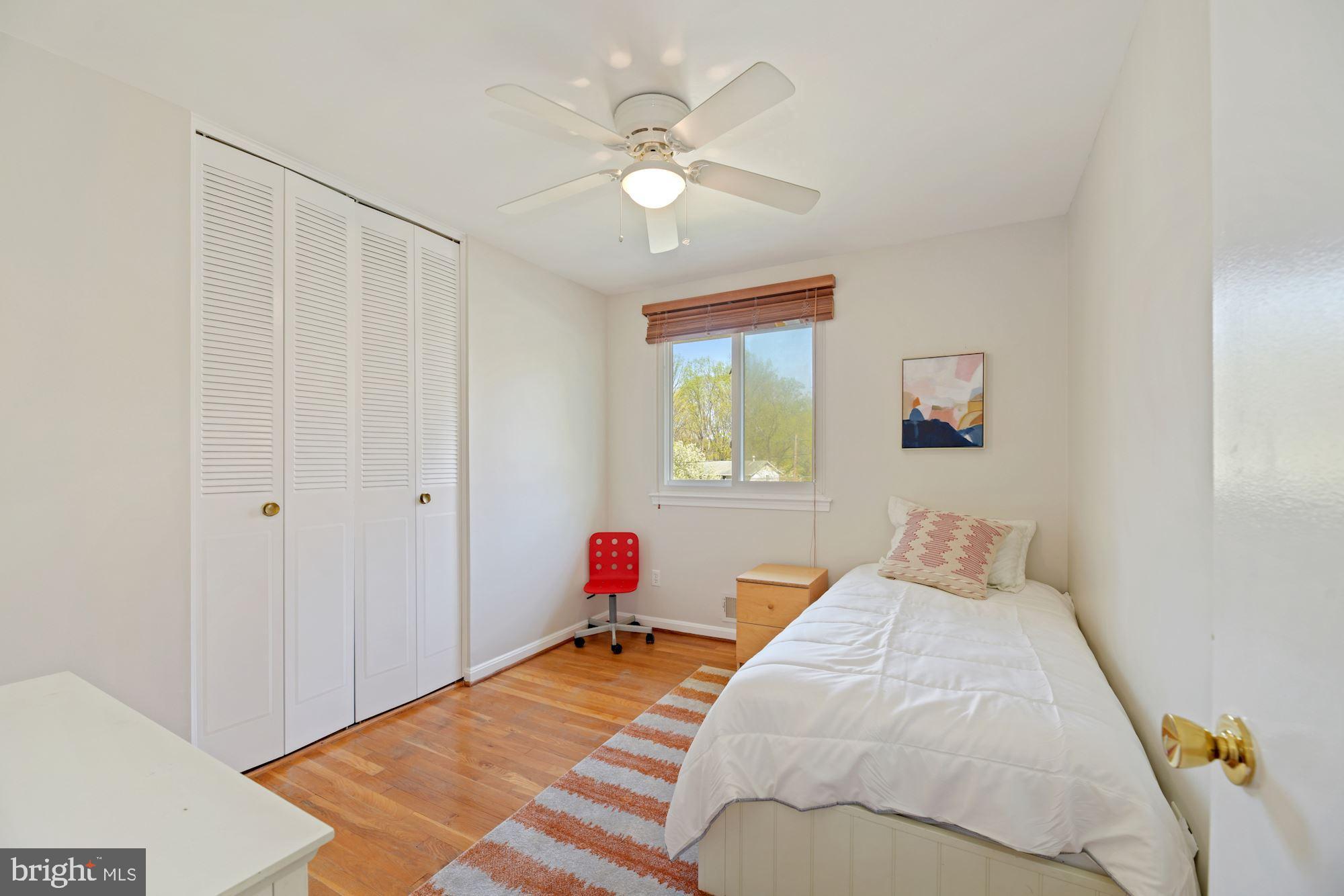 5228 Perth Court Springfield, VA 22151 - Photo 19 of 26 a bedroom with a bed and a chandelier