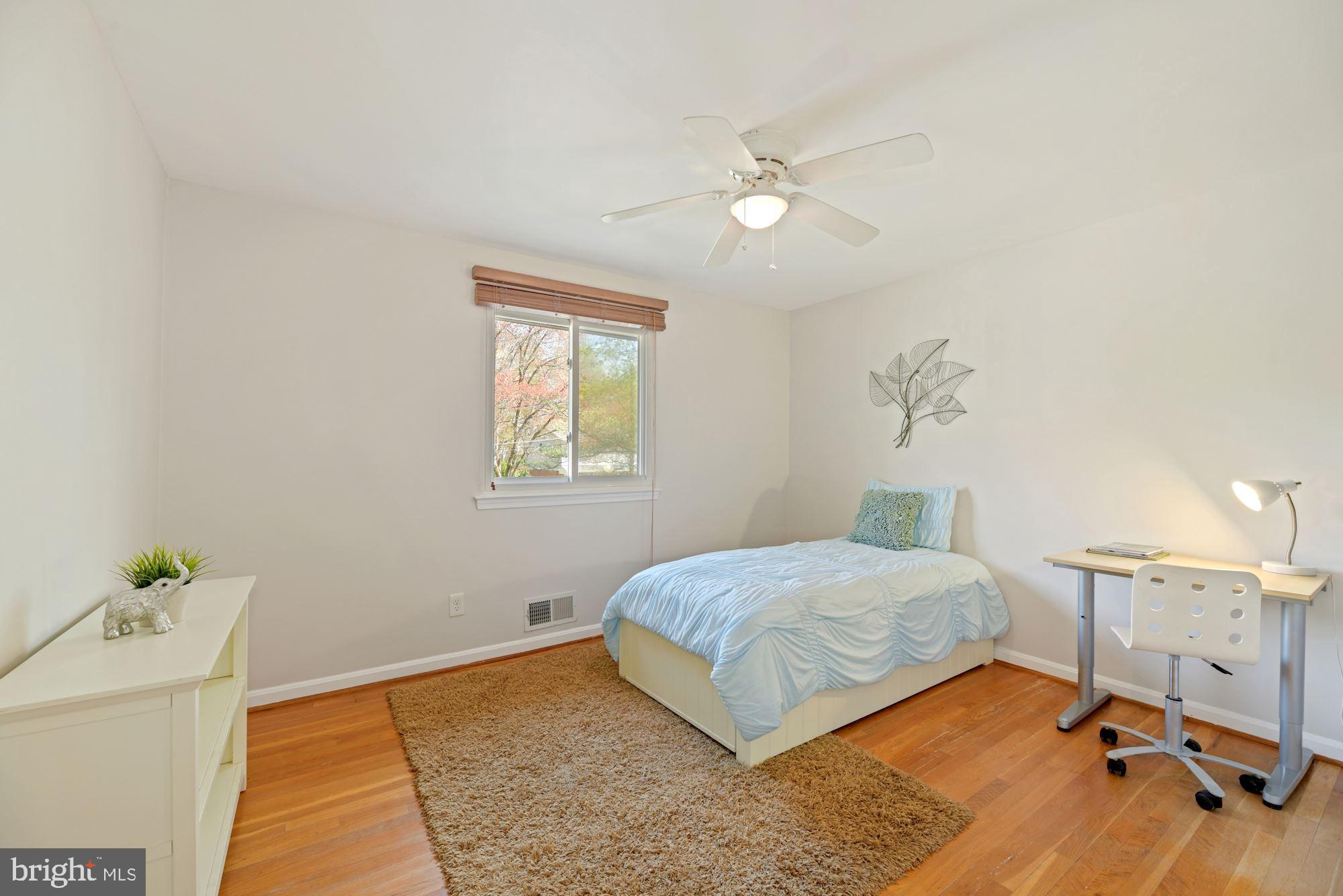 5228 Perth Court Springfield, VA 22151 - Photo 21 of 26 a bedroom with a bed and a chandelier