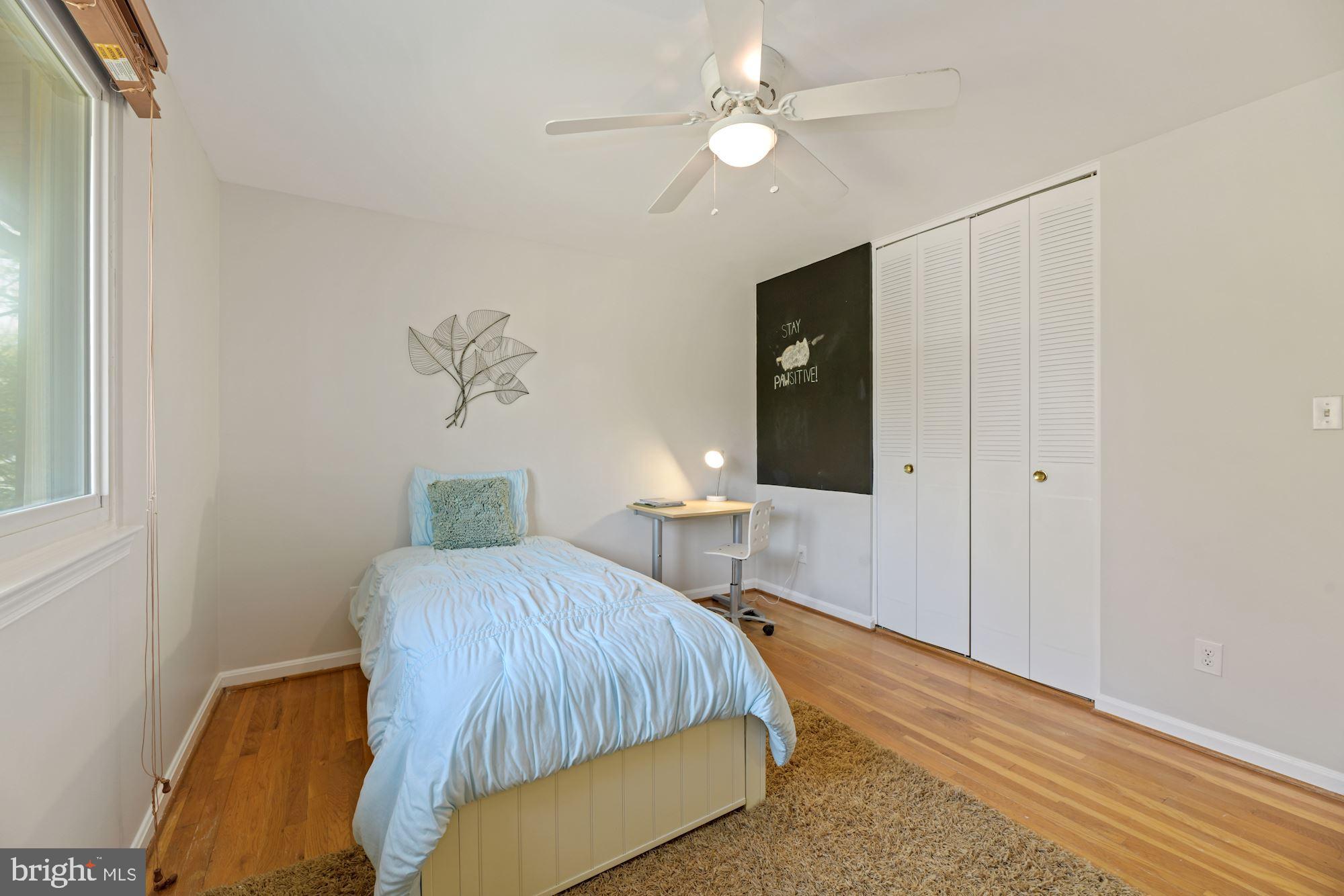 5228 Perth Court Springfield, VA 22151 - Photo 22 of 26 a bedroom with a bed chandelier and a window