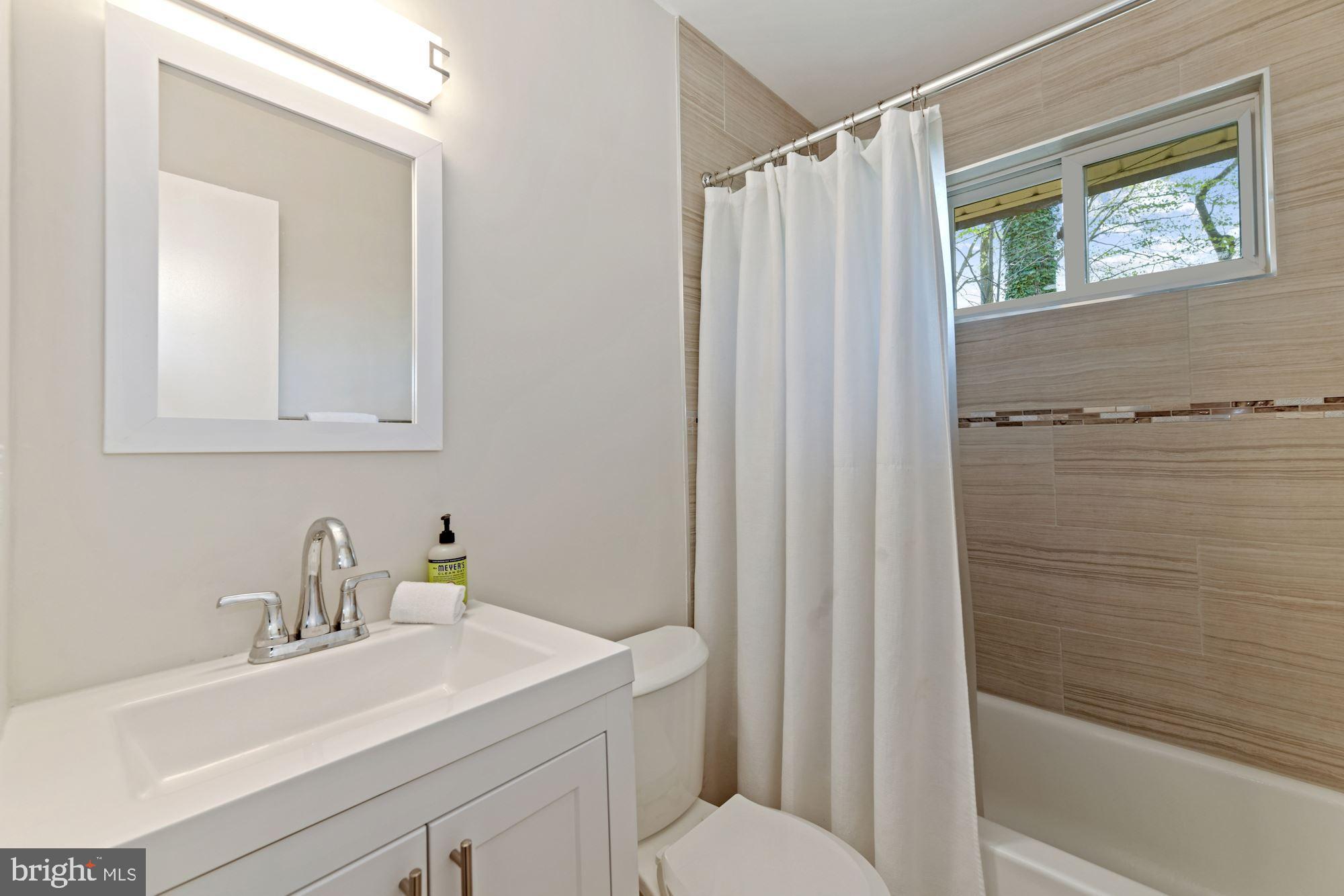 5228 Perth Court Springfield, VA 22151 - Photo 25 of 26 a bathroom with a sink and a mirror
