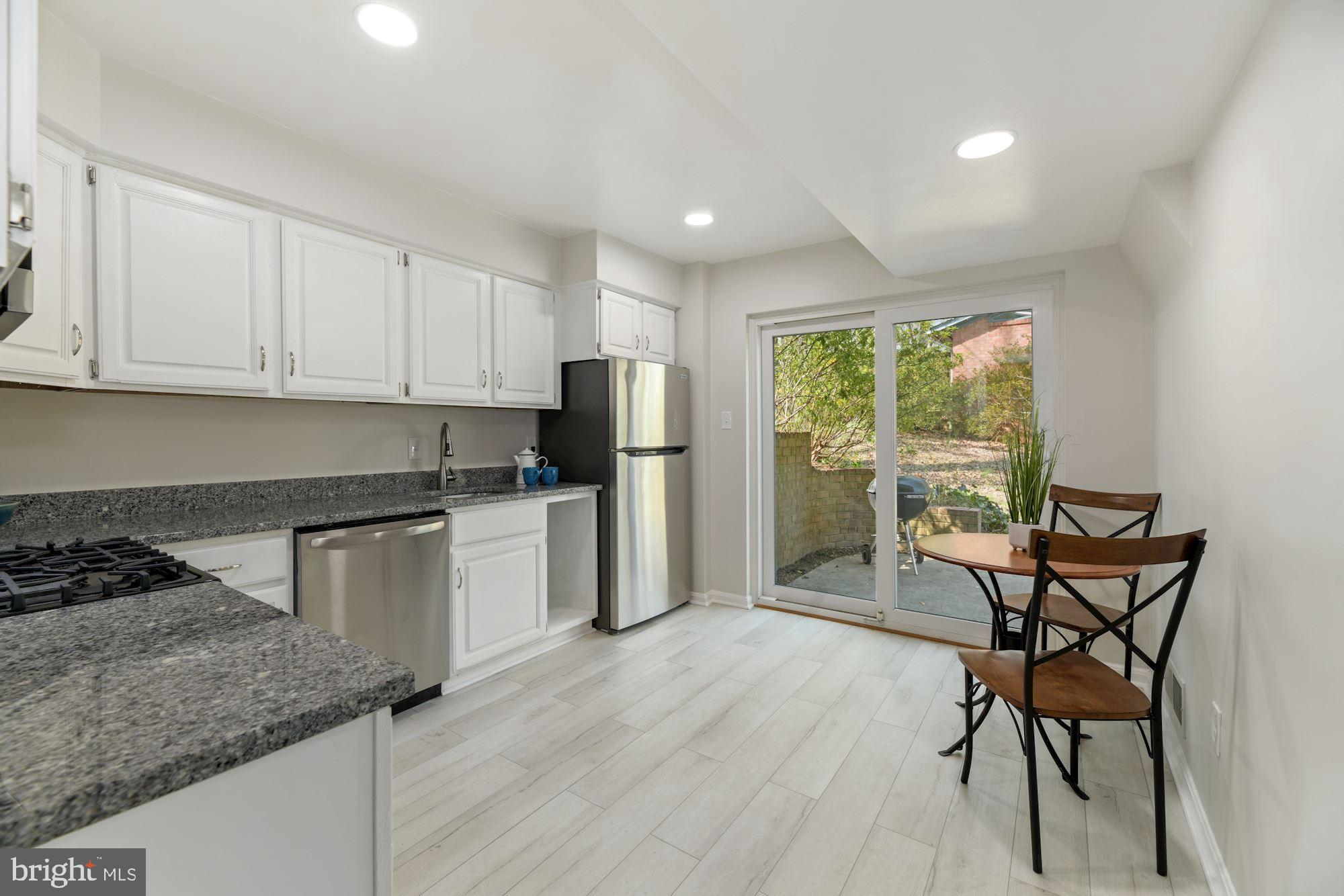 5228 Perth Court Springfield, VA 22151 - Photo 7 of 26 a kitchen with granite countertop wooden cabinets and stainless steel appliances