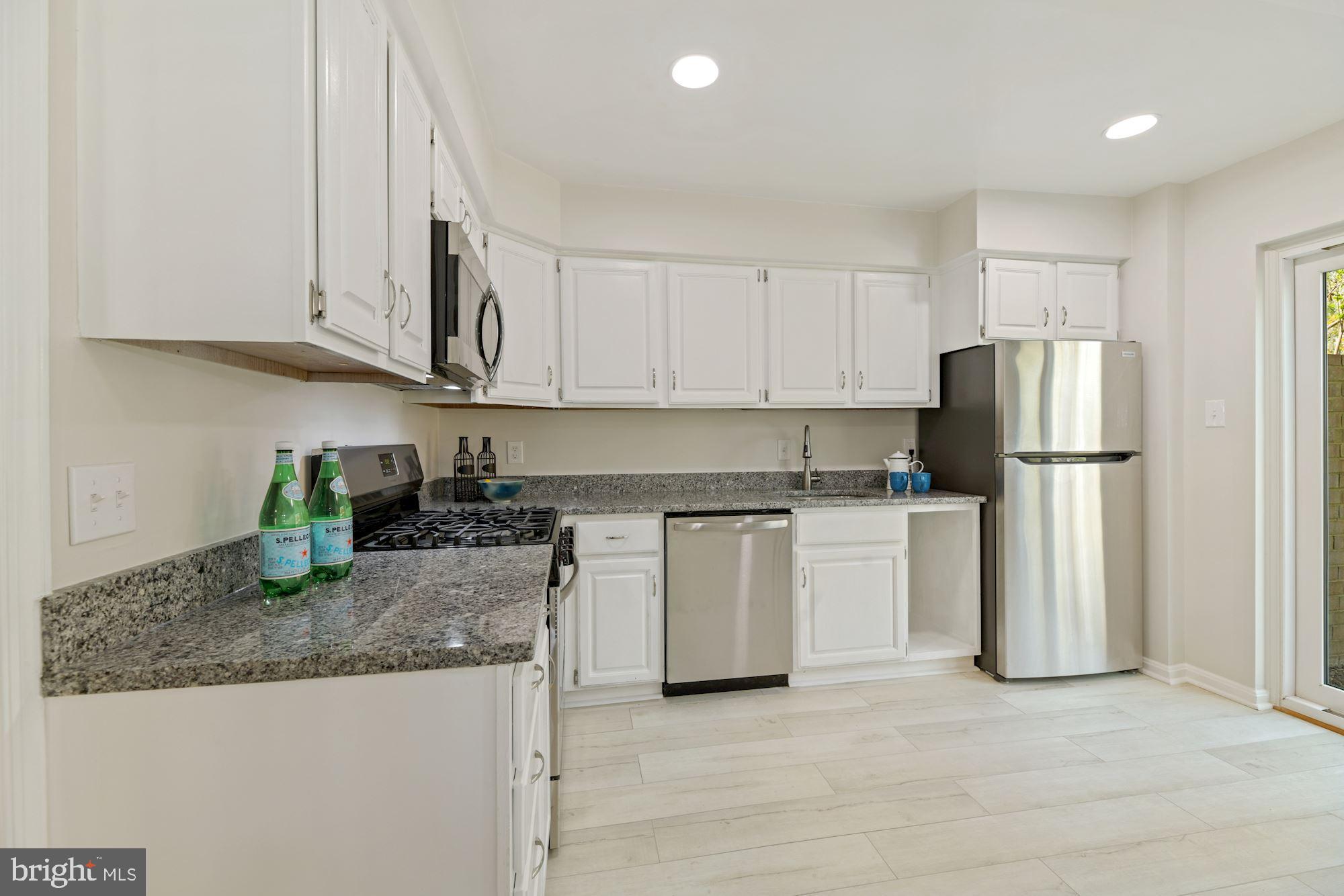 5228 Perth Court Springfield, VA 22151 - Photo 8 of 26 a kitchen with granite countertop a refrigerator stove top oven and sink