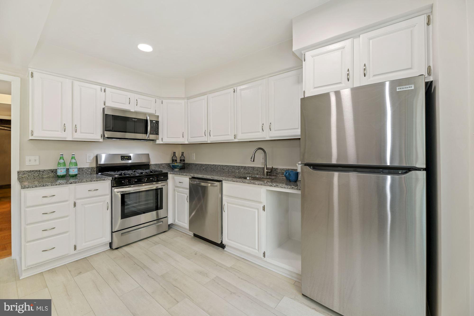 5228 Perth Court Springfield, VA 22151 - Photo 9 of 26 a kitchen with cabinets stainless steel appliances and a window