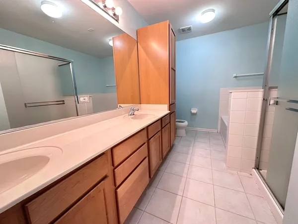 a bathroom with a double vanity sink and mirror