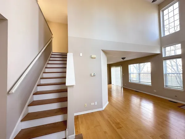 a view of an entryway with wooden floor and windows