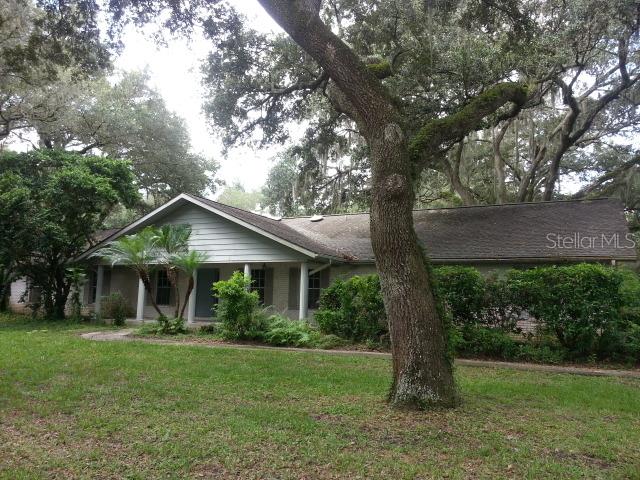 4753 Ryals Road Zephyrhills, FL 33541 - Photo 1 of 1 a front view of house with a garden