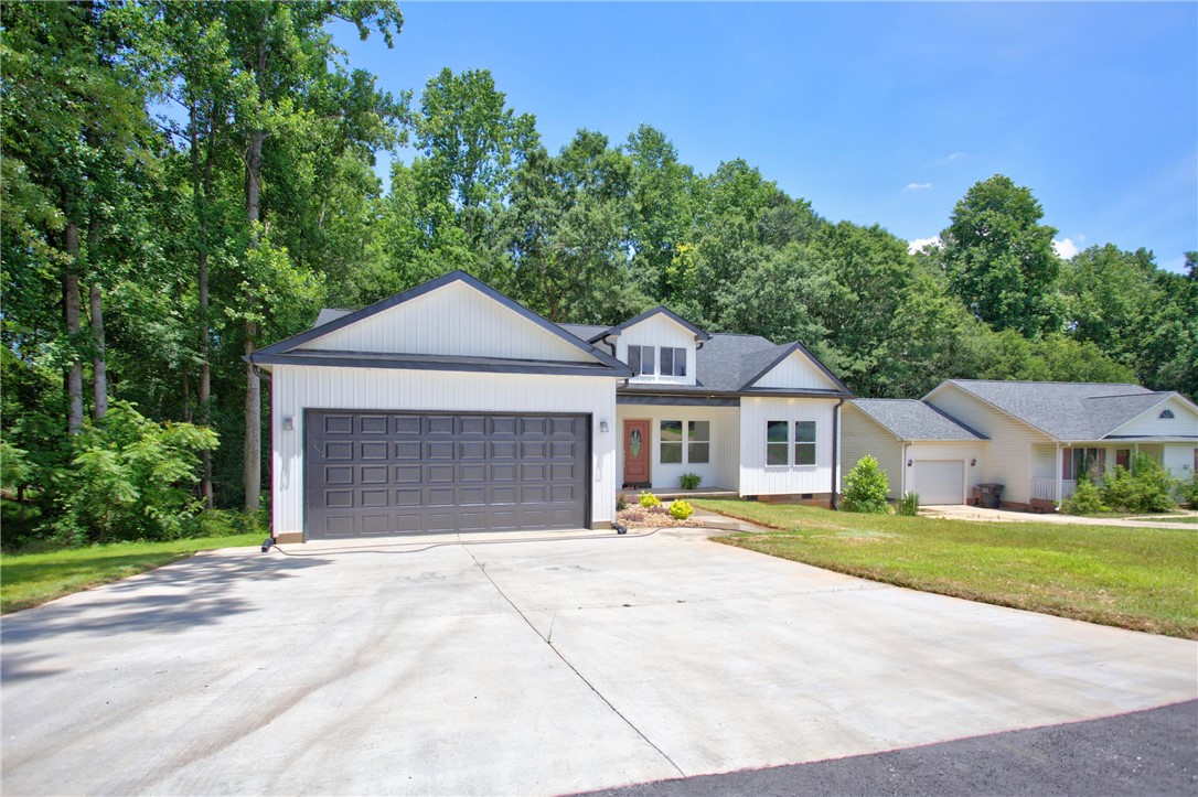 223 Maple Drive Anderson, SC 29621 - Photo 41 of 45 A newly constructed residence boasts an attached garage, a spacious concrete driveway, and verdant surroundings.