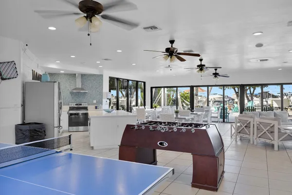 a living room with furniture a large window and a table