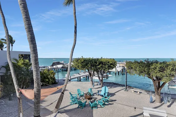 a view of a lake with boats and trees in the background