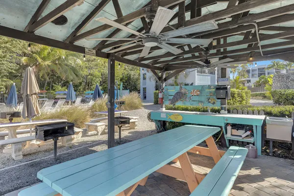 a view of a terrace with couches and an umbrella