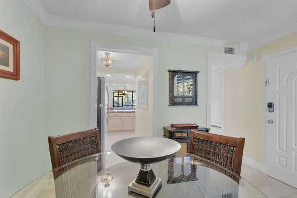 a view of a dining room with furniture and a chandelier