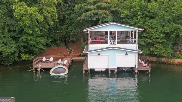 a blue swimming pool is sitting in the backyard of a house