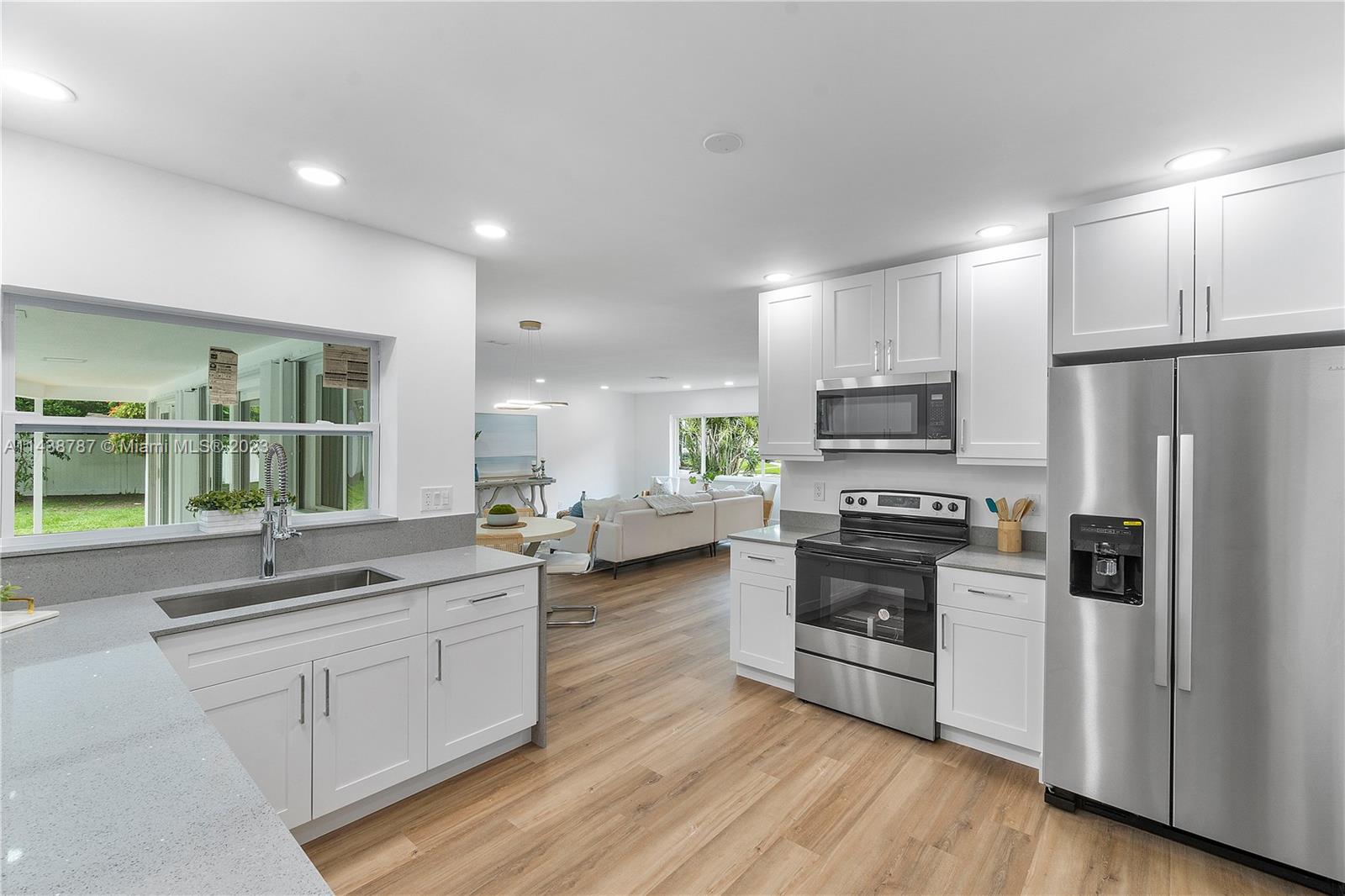 900 Northwest 9th Way Boca Raton, FL 33486 - Photo 14 of 48 a kitchen with stainless steel appliances a refrigerator sink and stove top oven