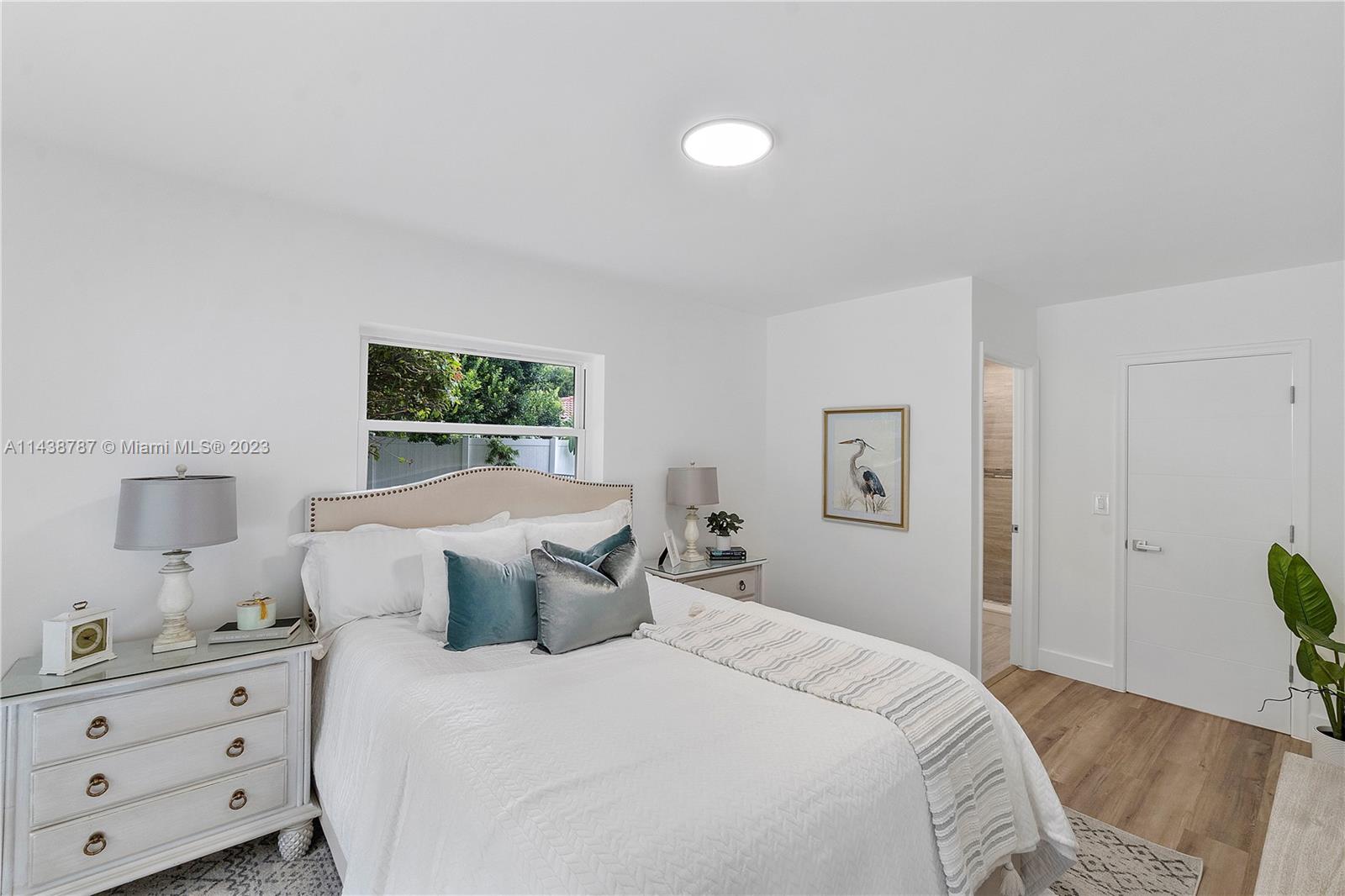 900 Northwest 9th Way Boca Raton, FL 33486 - Photo 22 of 48 a bedroom with a bed and a window