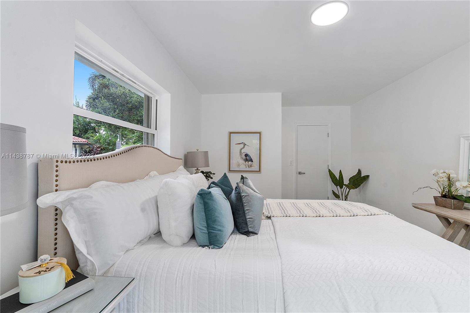 900 Northwest 9th Way Boca Raton, FL 33486 - Photo 23 of 48 a bed sitting in a bedroom next to a window