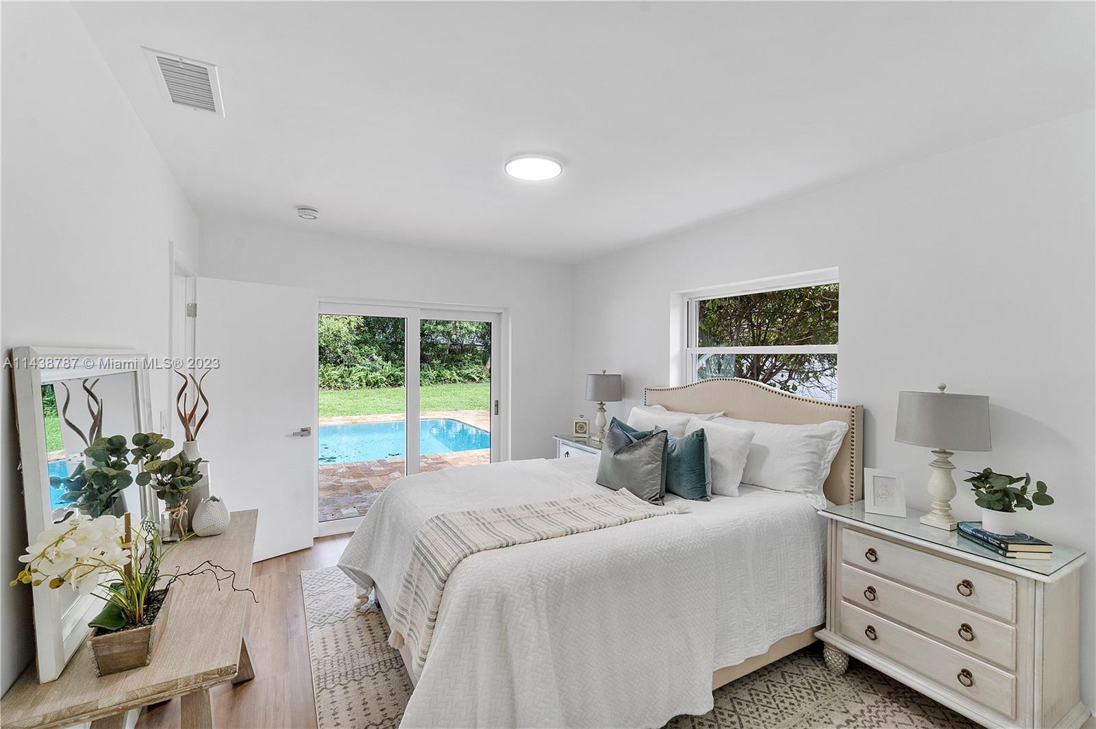 900 Northwest 9th Way Boca Raton, FL 33486 - Photo 25 of 48 a bedroom with a bed and a window