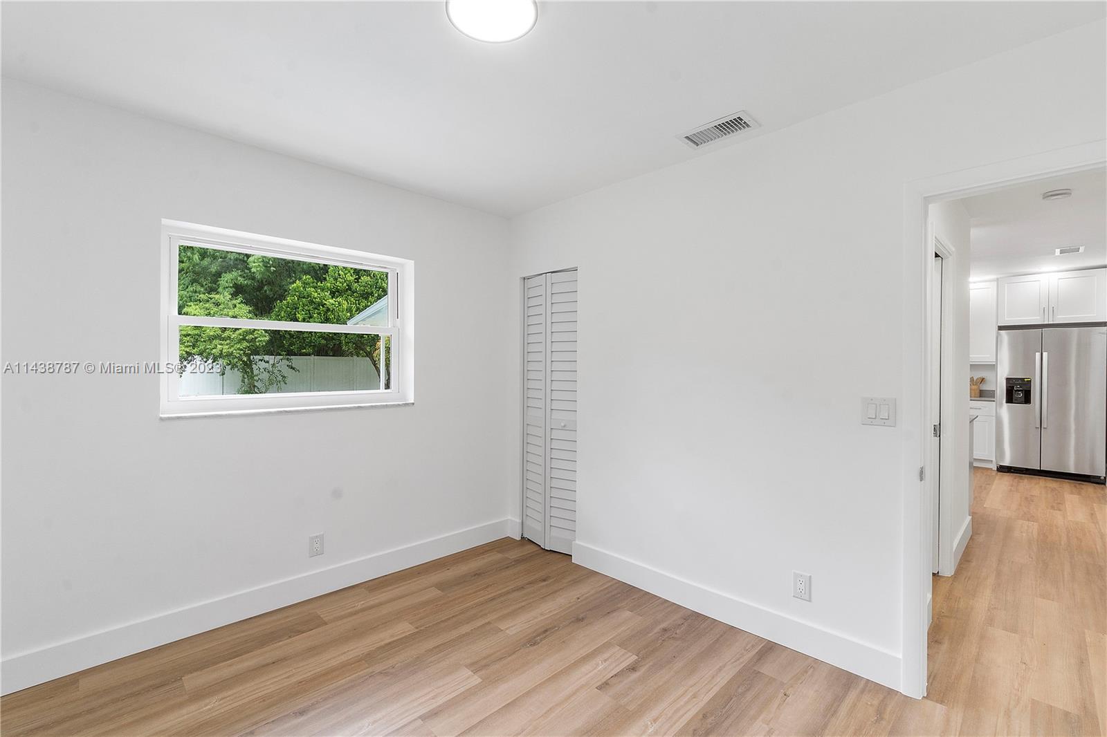 900 Northwest 9th Way Boca Raton, FL 33486 - Photo 37 of 48 an empty room with wooden floor and windows