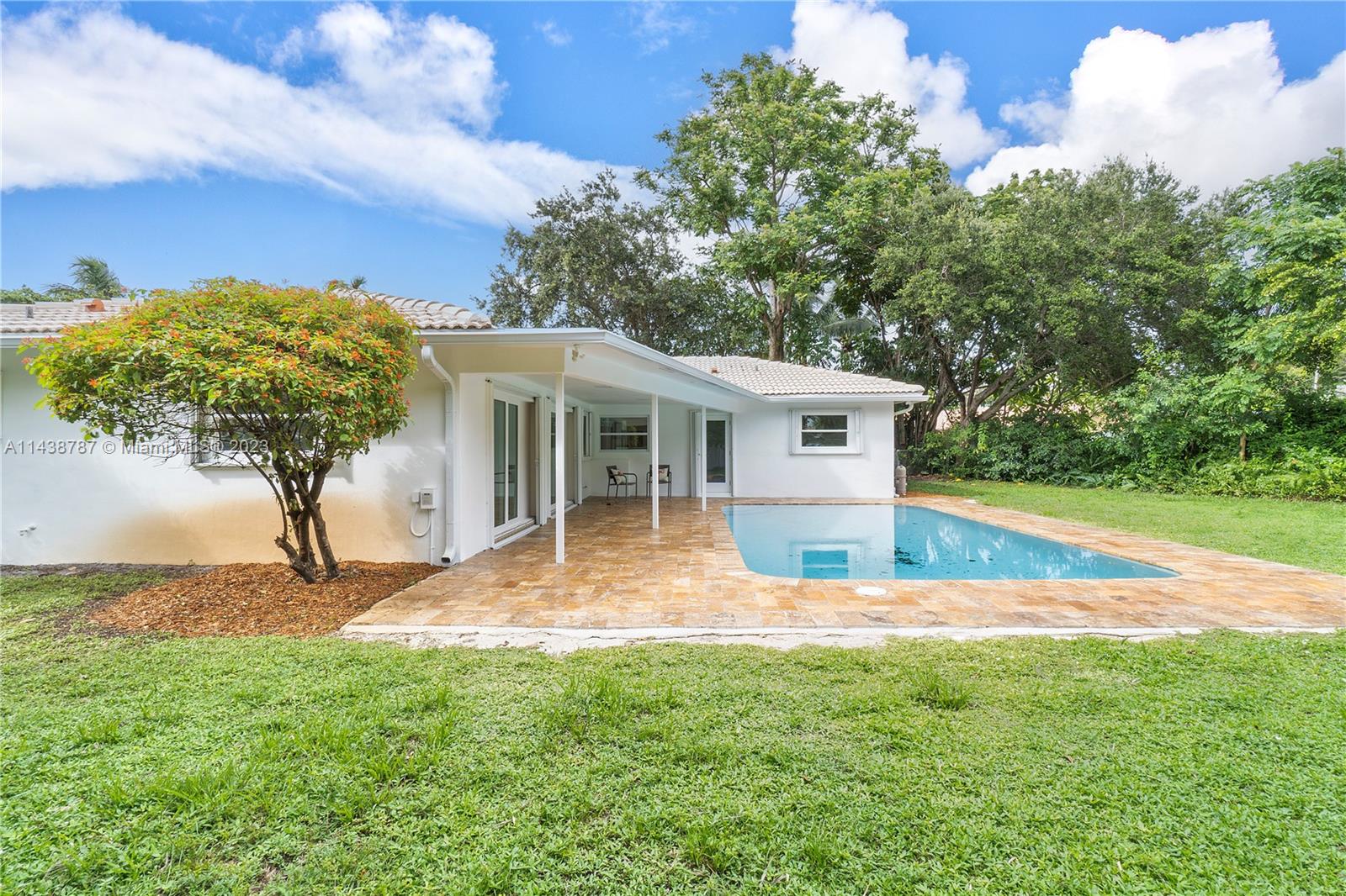 900 Northwest 9th Way Boca Raton, FL 33486 - Photo 43 of 48 a view of a house with pool and a yard