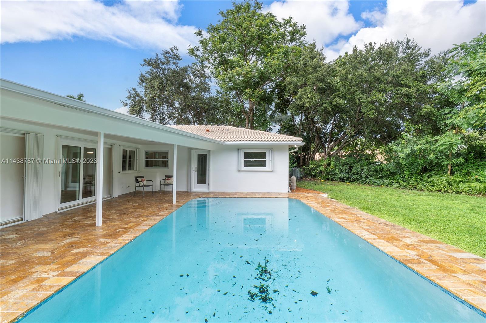 900 Northwest 9th Way Boca Raton, FL 33486 - Photo 48 of 48 a view of a house with a swimming pool and a yard