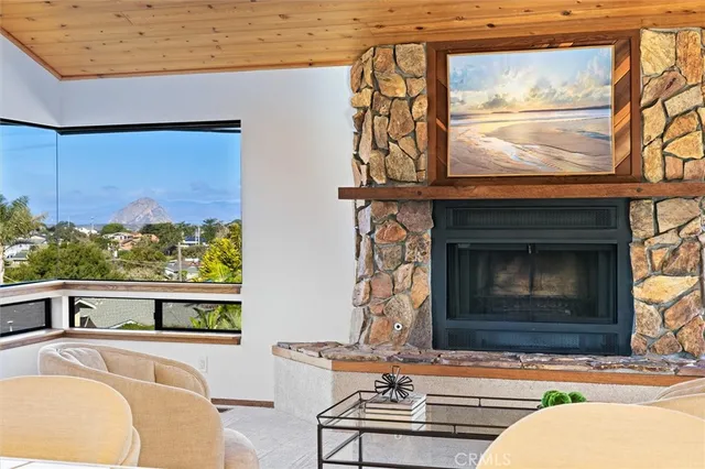 a living room with fireplace furniture and a window