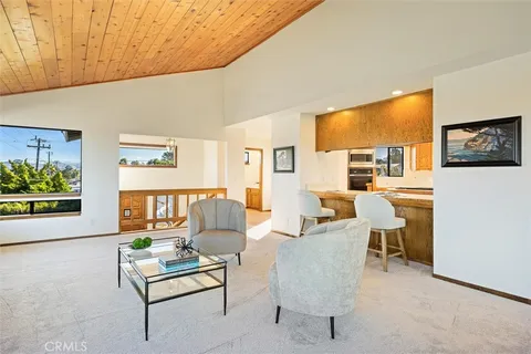 a living room with fireplace furniture and a window