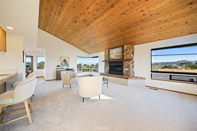a living room with furniture a flat screen tv and a large window