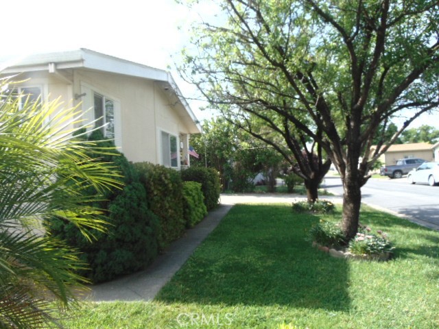 3835 Gardiner Ferry Road, Unit 62 Corning, CA 96021 - Photo 6 of 34 a yellow house with garden in front of it