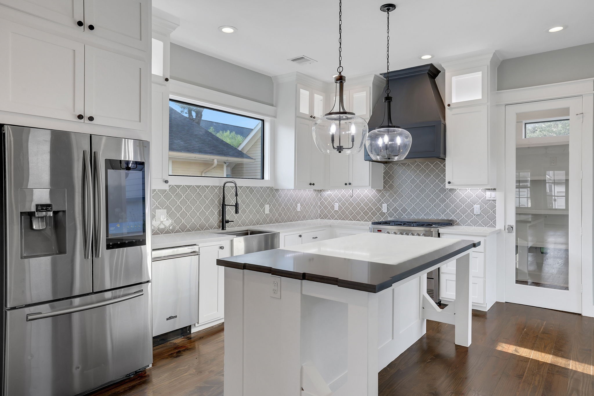 914 Robbie Street Houston, TX 77009 - Photo 15 of 50 a kitchen with stainless steel appliances granite countertop a sink a refrigerator and a stove